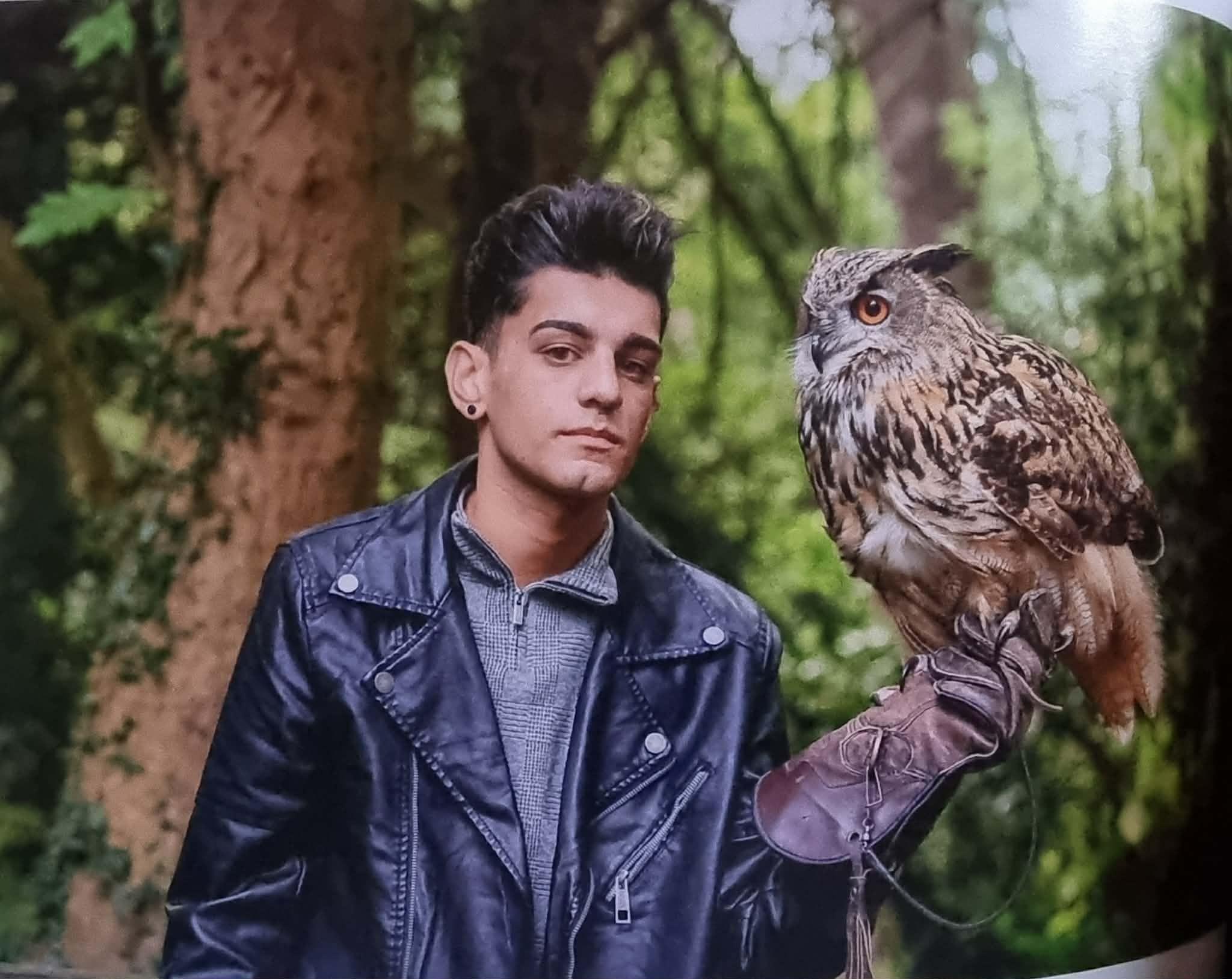 Bailey Lister  stands with one of his Owls which was one of the animals he cared for.